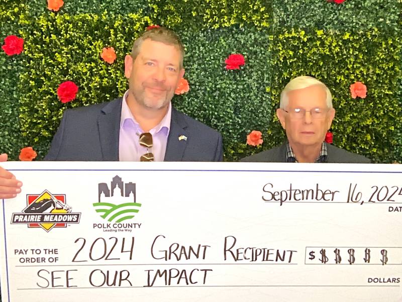 Colfax City Administrator Wade Wagoner and mayor David Mast accept a grant for $10K.
