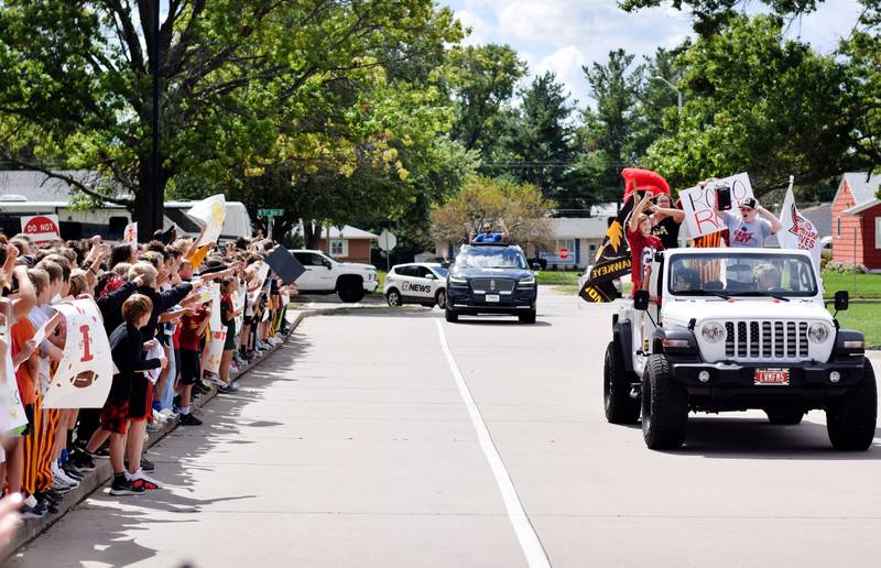 Students selected to lead the RVTV crews through a mini-parade outside Berg Middle School on Sept. 4 wave and pose to their fellow classmates.