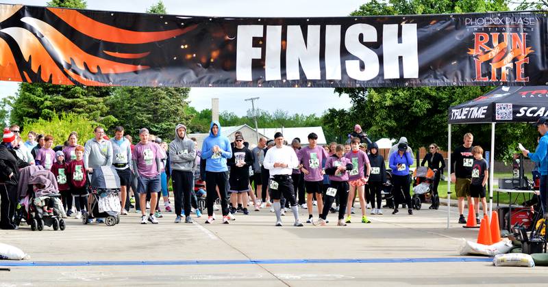 Runners participate in The Phoenix Phase Initiative's fifth annual Run For Her Life 5K and Half-Marathon on May 17 at Legacy Plaza in Newton. More than 110 people showed up for the run.
