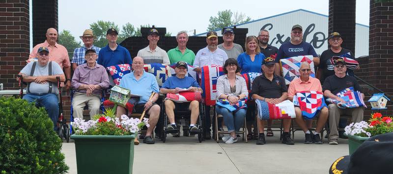 Nineteen Quilts of Valor recipients include standing from left: Scott Gilje, Doug Wilson, Bill Rice, Raymond Stecker, David Dominy, Greg Townley, William Kollasch, Janet Townley, Jonathan Buys, Kurt Kollasch and Norman Stoll; seated from left: David Annis, Harold Hill, John Duden, John Borts, Melissa Gilje, Bill Pion, James Clingman, David Wadsworth. Not pictured Ezra Rice (in-home individual award).