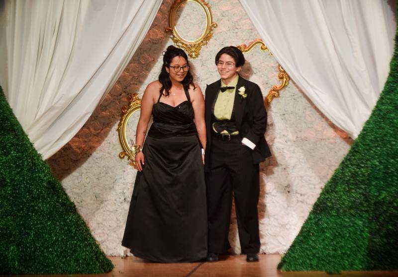 High schoolers pose for photographs before and after entering the auditorium for prom night on Aug. 15 at the Newton High School. Cardinals met for photos at a heart-shaped display on the stage before enjoying the festivities of prom night.
