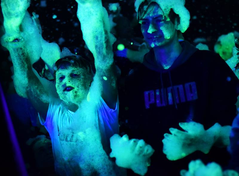 Kids participate in Driving Cap Entertainment's UV Glow Foam Party during Newton Fest on June 9 in Maytag Park in Newton.