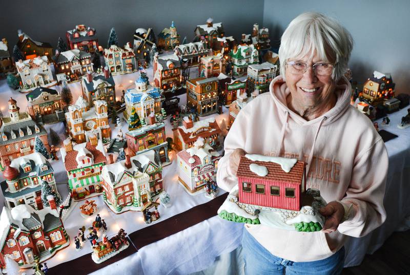 Sandi Rodgers, of rural Newton, showcases her collection of "holiday houses" that she has received from her son every Christmas since he was 8 or 9 years old. Her son, Joe, is now 45 years old. Rodgers says she has about 50 buildings in her collection, and she arranges them like a town with the help of her grandchildren.