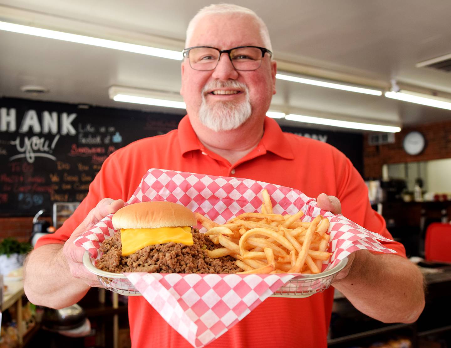 Michael Brown Sr., owner of Sandwiches Made Right doing business as Dan’s Sandwich Shop, serves a Cheese Rite and fries. The Newton restaurant was featured in the May 14 online issue of The Economist, which showcased a signature Iowa food: loose meat sandwiches.