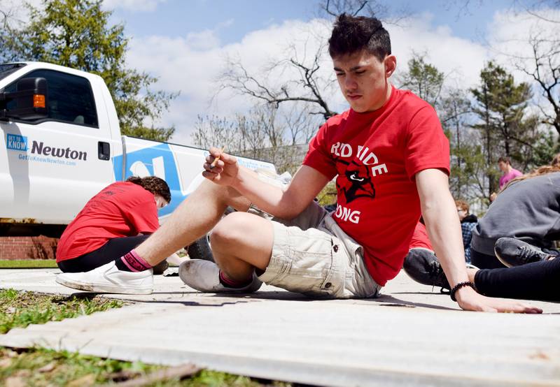 Newton students on May 4 painted Christmas light displays for the city's Maytag Park Holiday Lights during Red Pride Service Day.