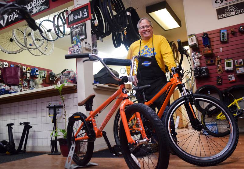 Joe Urias, owner of Mojo Cycling, showcases two newly built bikes inside his downtown shop. Mojo Cycling is involved in the Book for a Bike program at the Newton Community School District, which offers second and third grade students in every elementary school a chance to win a bike for meeting their reading goals.
