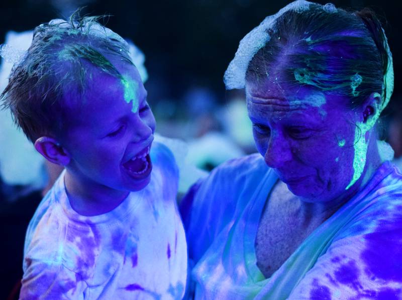 Kids participate in Driving Cap Entertainment's UV Glow Foam Party during Newton Fest on June 9 in Maytag Park in Newton.