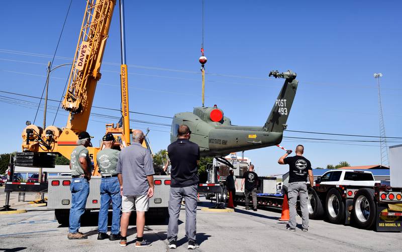 Crews from Midwest Aerospace and Dave's Crane & Wrecker Service help lift a Huey helicopter on Sept. 30 in Baxter.