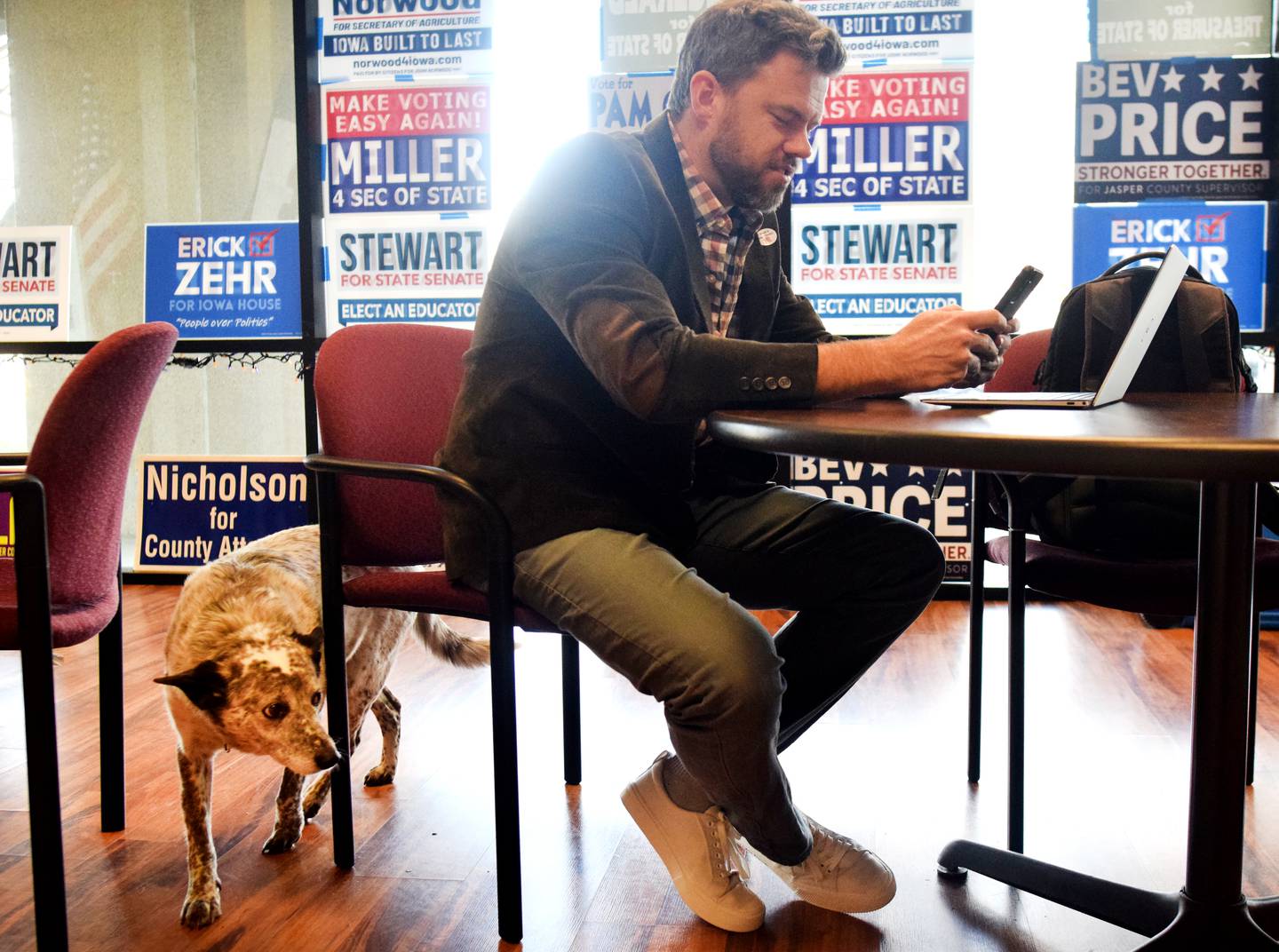 Erick Zehr, the Democratic candidate running for Iowa House District 38, is joined by his dog Kemba while tracking down absentee ballot voters at the Jasper County Democratic Party headquarters on Nov. 8 in Newton.