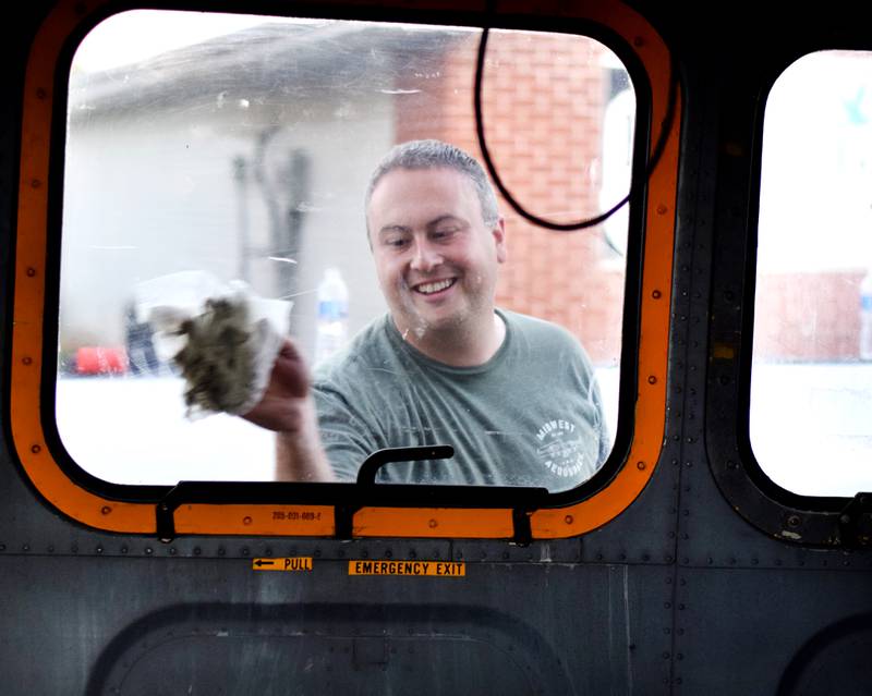 Joe Giannini of Midwest Aerospace wipes down a Huey helicopter on Sept. 30 in Baxter.