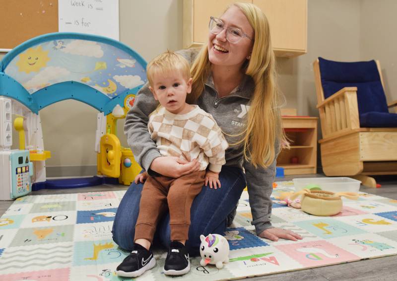 Serenity Bookout, childcare director for the Newton YMCA, plays with her son, Jaxton, who is enrolled in the facility's daycare program. After a local daycare announced it was going to close, the YMCA was contacted by several parents asking for help. The YMCA, already full at 123 kids, made room at the last minute to meet the needs of the community.