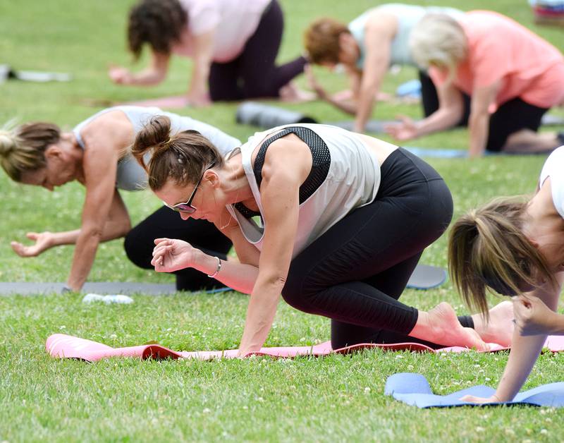 Residents participate in Yoga in the Park during Newton Fest in 2021 at Maytag Park.