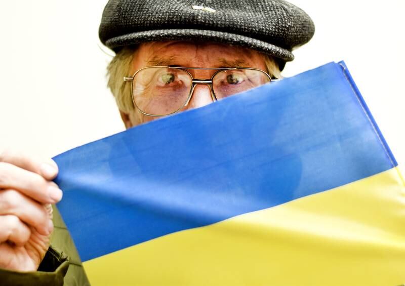 Marvin Campbell, a board member and co-founder of  the Organization Promoting Everlasting Neighbors (OPEN), holds a recreated Ukrainian flag. Campbell wants the organization to collaborate with businesses to post banners of the Ukrainian flag is support of Newton's sister city.