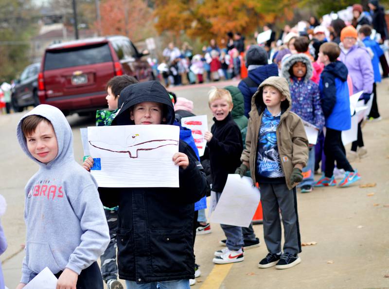 Newton Community School District students and staff participate in a Veterans Day Reverse Parade on Nov. 11, which extended to a number of school buildings in the area.