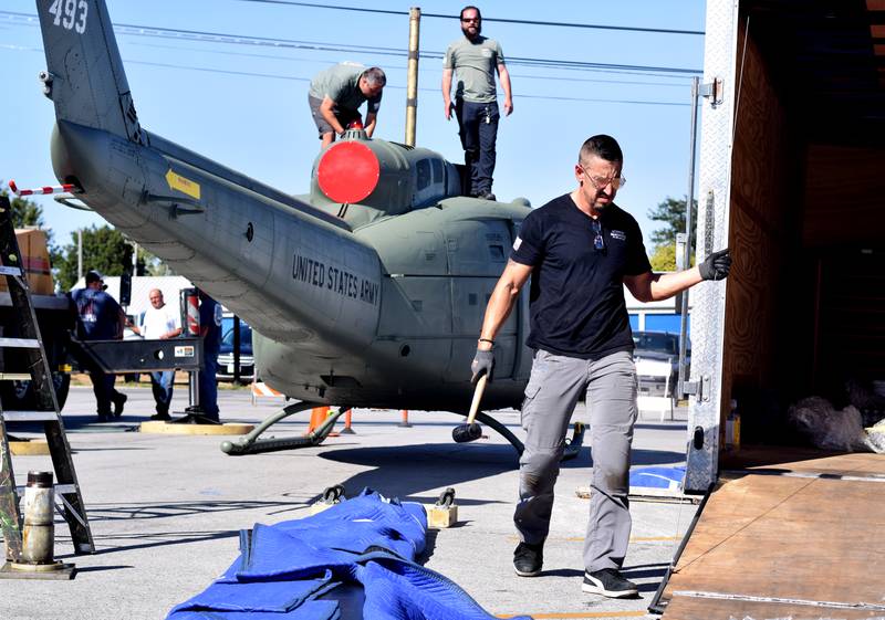 Crews from Midwest Aerospace prepare a Huey helicopter monument on Sept. 30 in Baxter.