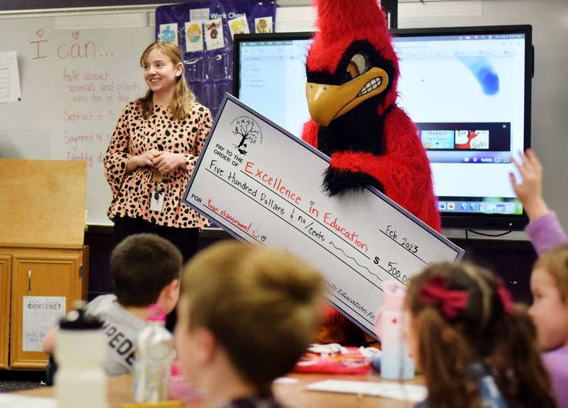 Lea Kunkel, a kindergarten teacher at Aurora Heights Elementary, on Feb. 9 receives a $500 check for her classroom after earning the Excellence in Education Award from the Newton Community Educational Foundation.