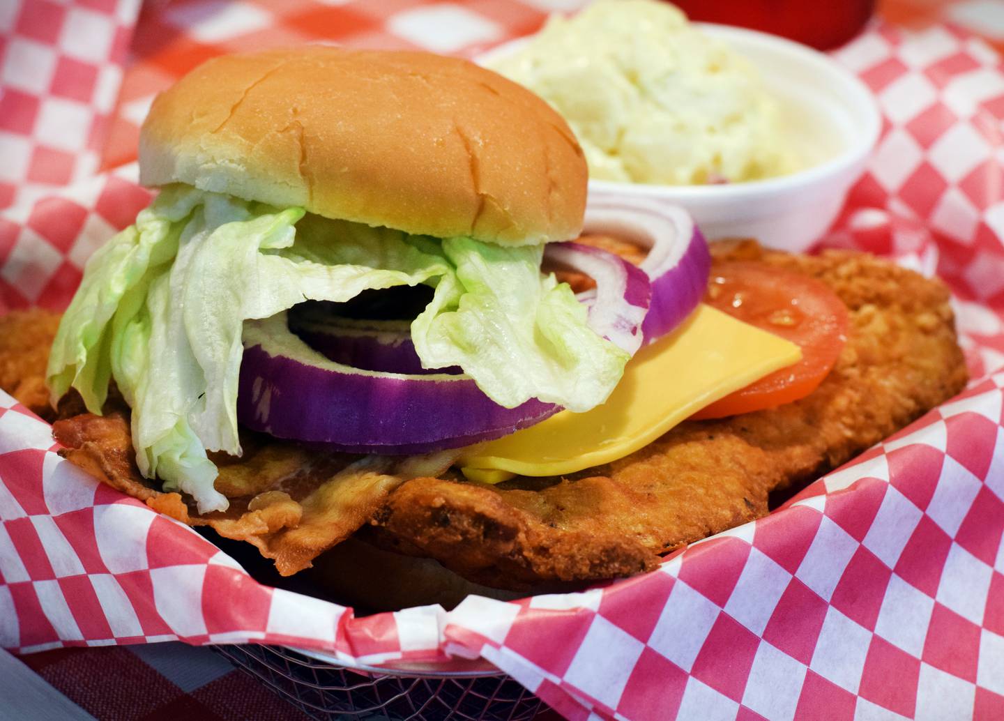 The whoppin' breaded tenderloin sandwich and a helping of potato salad is served at Sandwiches Made Right doing business as Dan’s Sandwich Shop in Newton.