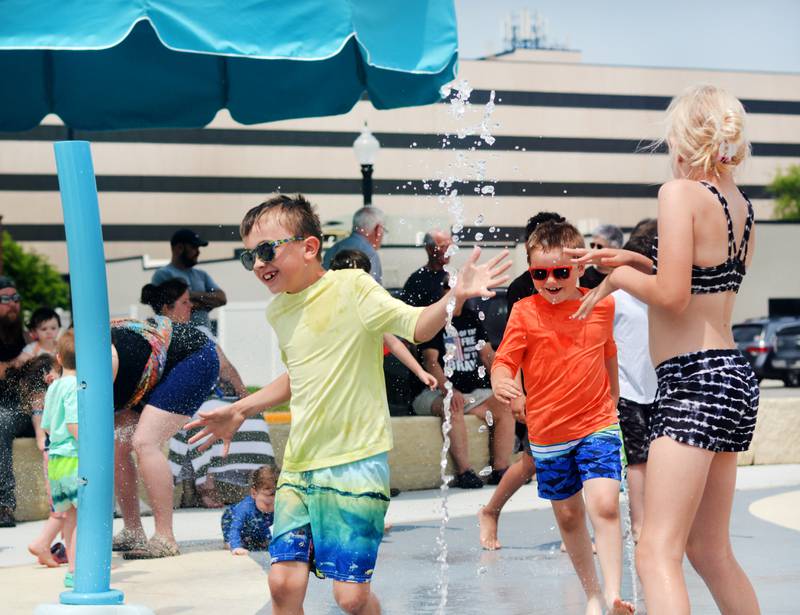 Families and children enjoy the new splash pad facilities. The Greater Newton Area Chamber of Commerce, Newton Main Street and the City of Newton held a ribbon cutting ceremony for the splash pad on June 6.