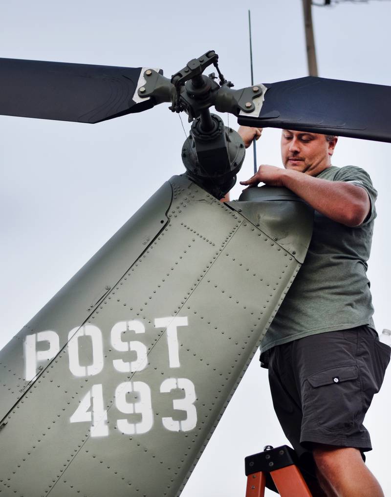 Joe Giannini of Midwest Aerospace adds the antenna to the Huey helicopter memorial on Sept. 30 in Baxter.