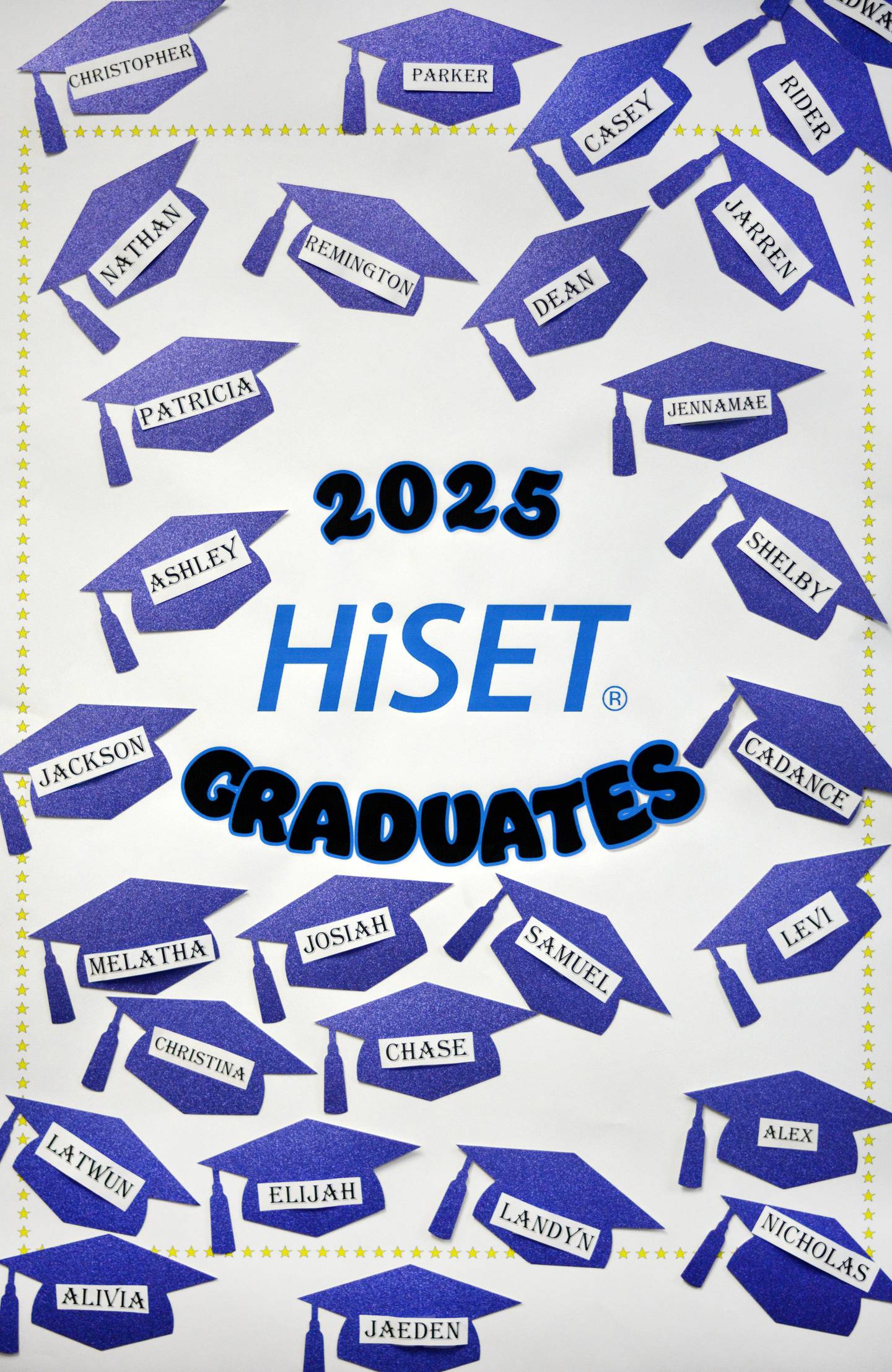 The names of approximately 30 graduates of the HiSET program at DMACC Newton Campus are on display on a poster.
