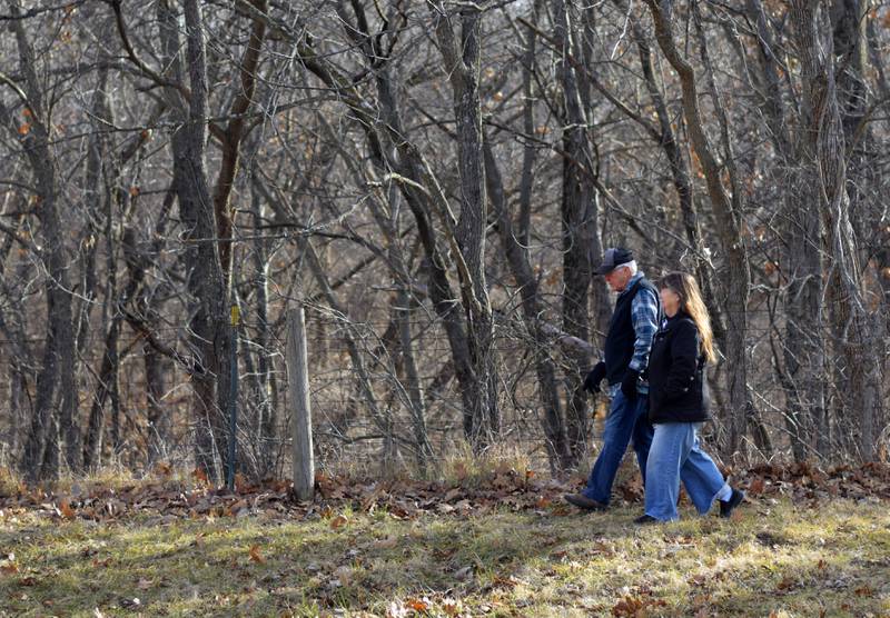 Gary and Mary Adams, of rural Colfax, walk along the fence line of their property, which will be moved to make way for the construction of a Level B road that was left unmaintained for several decades. Supervisors argue Jasper County could be liable for failure to maintain if the road is not extended to grant access to another property owner's 20-acre parcel.