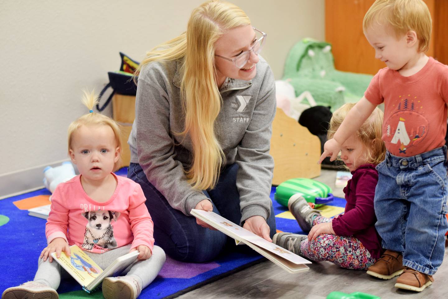 Serenity Bookout, childcare director for the Newton YMCA, plays with daycare children. After another local daycare announced it was going to close, the YMCA was contacted by several parents asking for help. The YMCA, already full at 123 kids, made room at the last minute to meet the needs of the community.