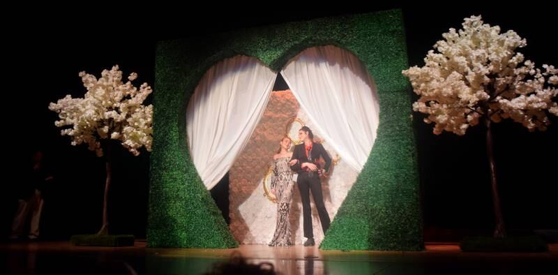 High schoolers pose for photographs before and after entering the auditorium for prom night on Aug. 15 at the Newton High School. Cardinals met for photos at a heart-shaped display on the stage before enjoying the festivities of prom night.