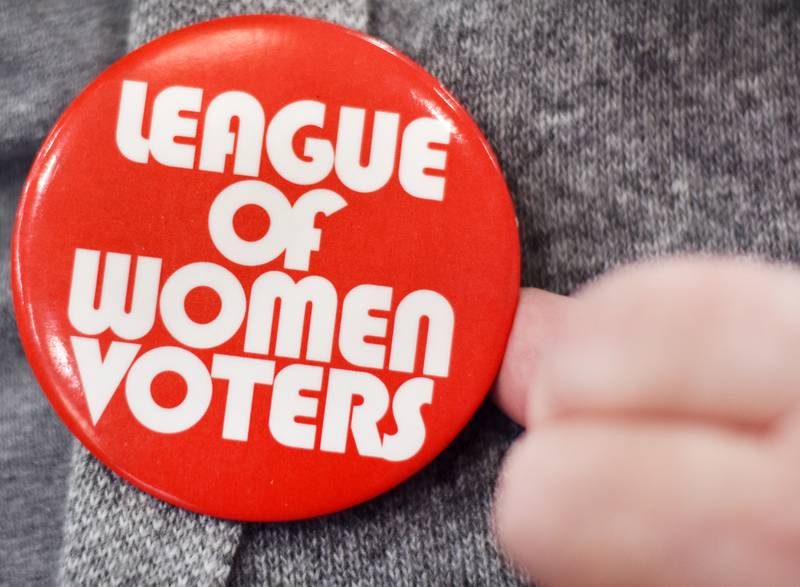 Bonnie Pitz, state board member of the League of Women Voters of Iowa, shows off a pin from the organization. For years, the League has held candidate forums/debates in Jasper County. Local Republican candidates are refusing to participate in the forums, citing frustrations over the group's lack of neutrality and a past mistake.