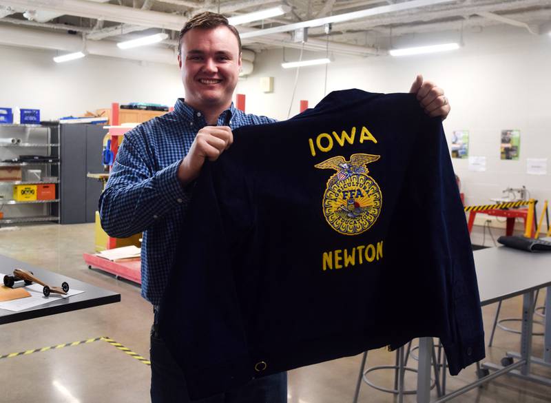 Jarret Horn, a career and technical education instructor at Berg Middle School and advisor to the building's Newton FFA students, holds up the organization's chapter jacket on May 2 inside his classroom. The middle school FFA was launched this past school year.