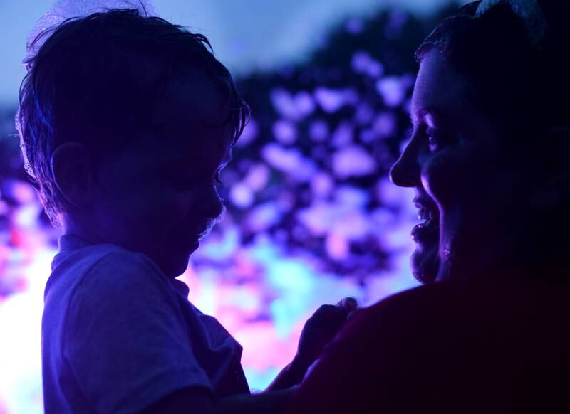 Kids participate in Driving Cap Entertainment's UV Glow Foam Party during Newton Fest on June 9 in Maytag Park in Newton.