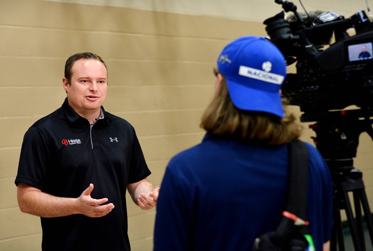 Cole Custer, a professional NASCAR driver, talks with media after answering a barrage of questions from with third-grade students on May 15 at Thomas Jefferson Elementary School.