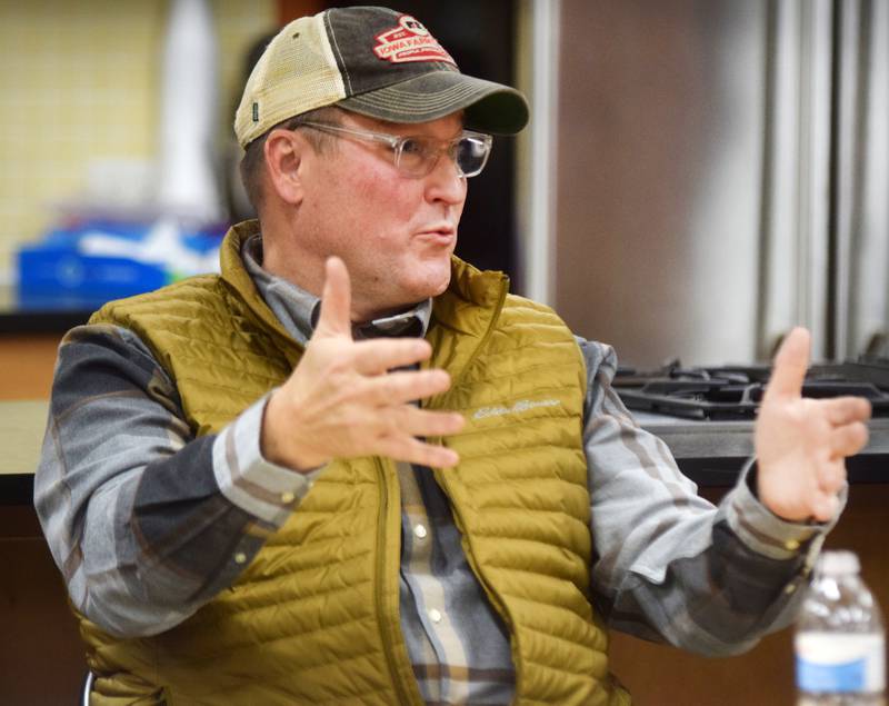 Rep. Jon Dunwell speaks with constituents during a legislative gathering hosted by the League of Women Voters of Jasper County on Jan. 21 at the Hy-Vee in Newton.