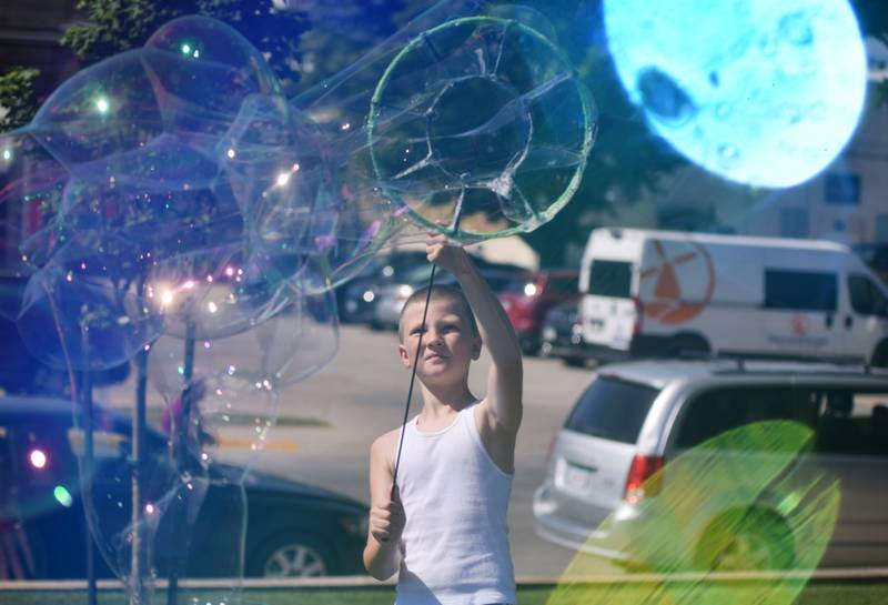 Lots of children participate in the Absolute Science Bubble Open House on June 20 at the Newton Public Library.