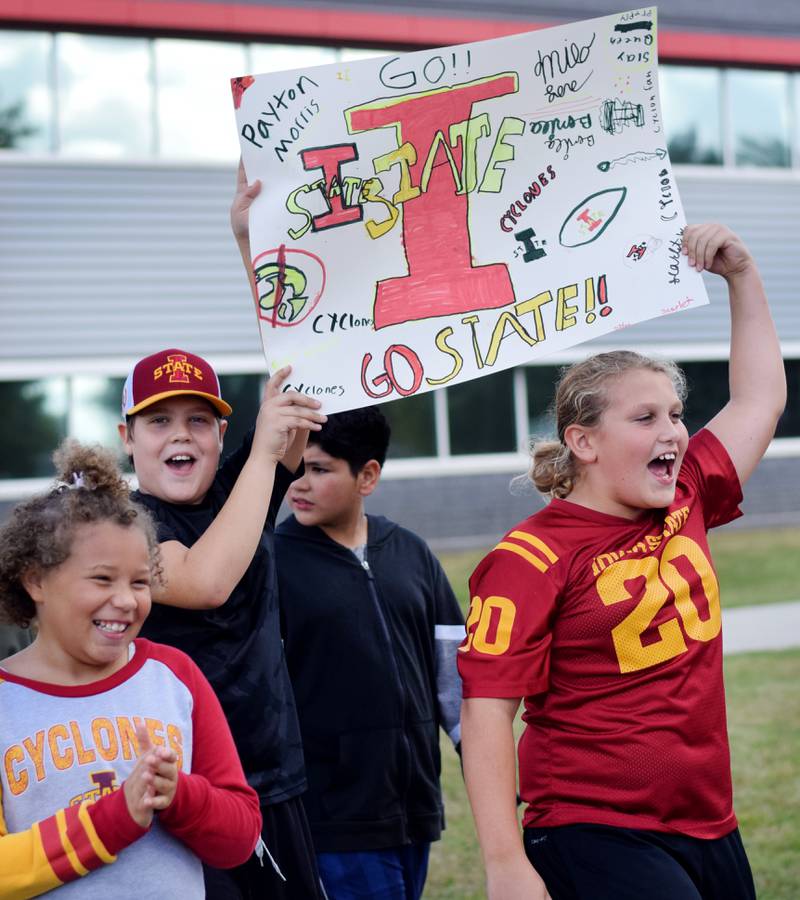 Students wearing Cyclone and Hawkeye apparel pose for pictures on Sept. 4 outside Berg Middle School. The whole study body was invited to welcome RVTV to town.