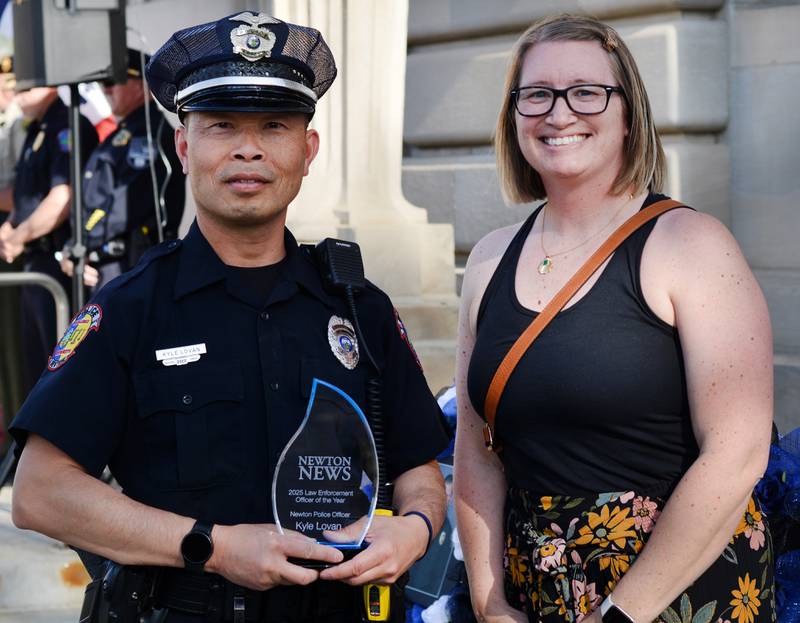Newton Officer Kyle Lovan receives the Jasper County Law Enforcement Professional of the Year Award from Newton News Editor Jamee A. Pierson.