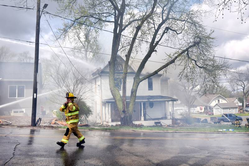 Firefighters from multiple agencies in Jasper and Polk Counties respond to a house fire on Thursday, April 20, near the 300 block of South Walnut Street in Colfax.