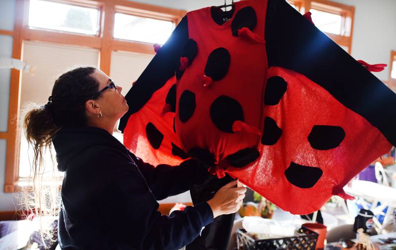 Teresa Lyman, a board member of Project AWAKE, adds the finishing touches to a ladybug scarecrow before the second annual Fall Fest and Scarecrow Walk on Oct. 12 at the Newton Arboretum & Botanical Gardens.