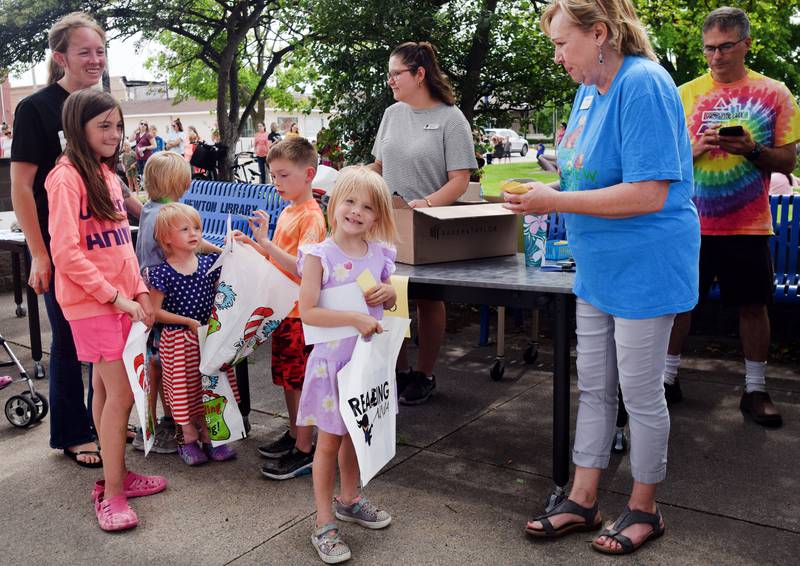 Families and children sign up for the Newton Public Library's summer reading program during its kickoff party in May on the library lawn. In total, the library recorded more than 800 registrations for the program, the most it has ever seen.
