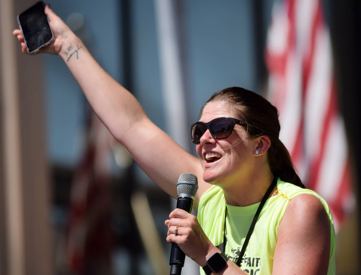 Kristi Cummins, president of Fierce Faith Music, announces performer Micah Tyler to the stage during Worship Fest on June 19 in downtown Newton.