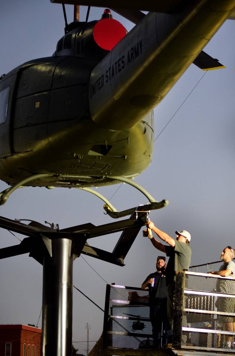 Crews work quickly to install anchors to the Huey helicopter memorial on Sept. 30 in Baxter.
