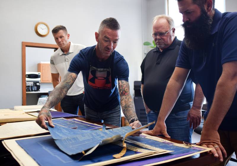 Jasper County Maintenance Director Adam Sparks shows off old blueprints of the courthouse to the board of supervisors during an Aug. 1 work session.