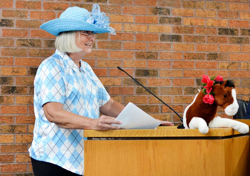 Ina Heidemann, vice-president of the board of directors at Newton Arboretum & Botanical Gardens, speaks to council members during their April 21 meeting wearing Kentucky Derby attire. The Newton Arboretum & Botanical Gardens will be hosting its spring plant sale May 2-3.