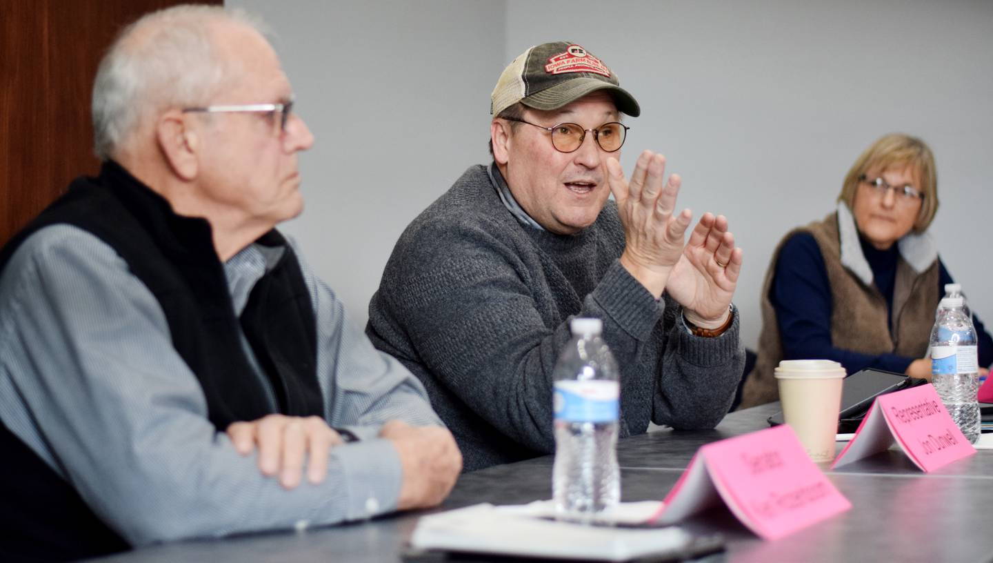 Rep. Jon Dunwell, center, responds to questions asked by constituents during a legislative gathering hosted by the League of Women Voters of Jasper County on March 18 in the Newton Public Library.