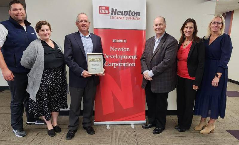Kevin Stensrud, Holly Smith, Frank Hansen, Steve Burnett, Lorrie Klawonn and Stephanie Shutts of Mahaska Communication Group pose for a picture with their award received Oct. 12 at the Newton Development Corporation's Salute to Business & Industry.
