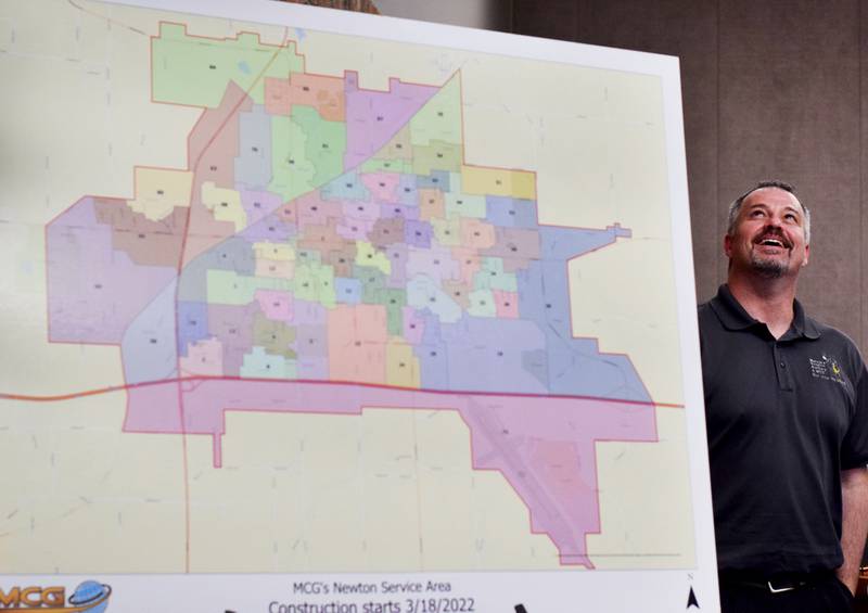 Jason Hewitt, engineering and construction manager of Mahaska Communication Group, speaks during the March 21 city council meeting in Newton and shows off the service map of the company's broadband system.