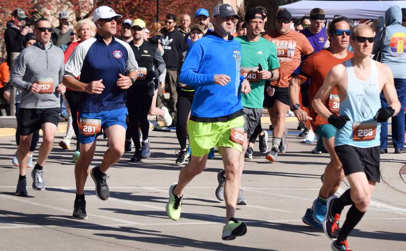 Runners, walkers and young bikers take off for the Run For Her Life 5K organized by nonprofit Phoenix Phase Initiative on April 29 at Legacy Plaza in Newton.