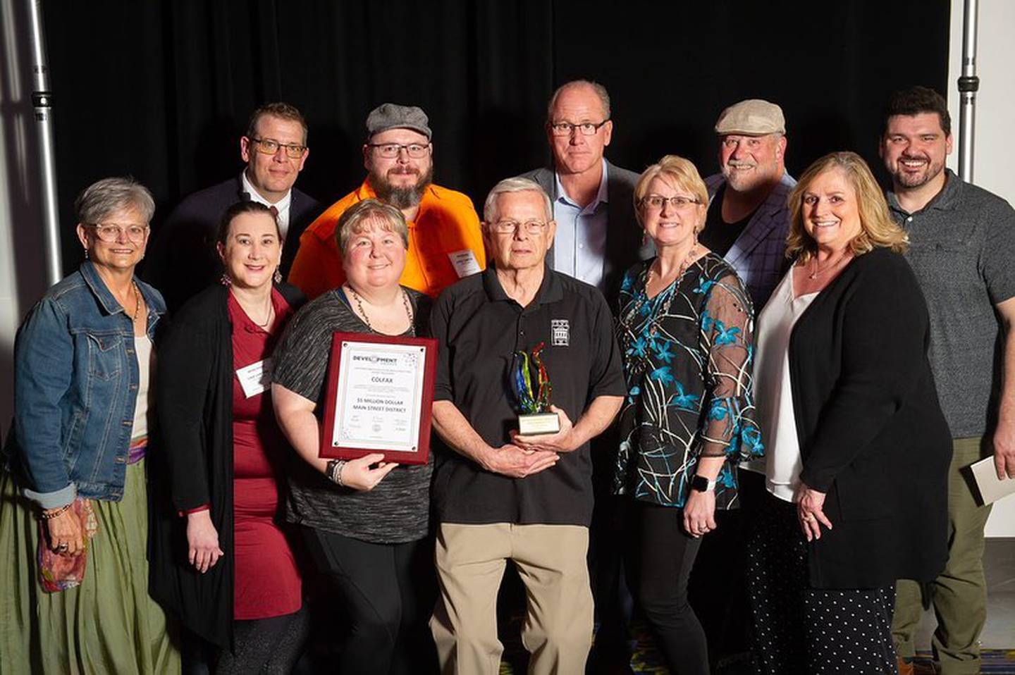 Representatives of Colfax Main Street and the City of Colfax receive an award April 22 at the Main Street Iowa Development Awards in Des Moines. Iowa Gov. Kim Reynolds and Debi Durham, executive director of Iowa Economic Development Authority and Iowa Finance Authority, presented the awards.
