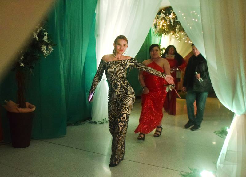 High schoolers pose for photographs before and after entering the auditorium for prom night on Aug. 15 at the Newton High School. Cardinals met for photos at a heart-shaped display on the stage before enjoying the festivities of prom night.