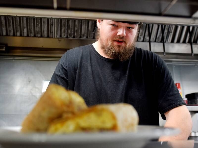 James Webster, the former cook of Midtown Cafe, finishes an order during the soft opening of Mid-Rite Cafe, a partnership between the old downtown diner and the Newton Maid-Rite. From now on starting Nov. 29, a Midtown Cafe breakfast menu will be served to patrons. Afterward the restaurant will transition back to the Newton Maid-Rite for lunch and dinner.