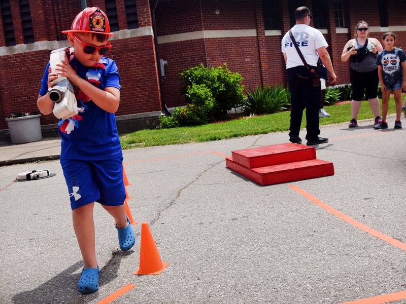 Kids participate in obstacle courses and take a try at the fire hose during Safety Fest on June 8 in Maytag Park. Safety Fest is regularly organized by the Newton Fire Department.